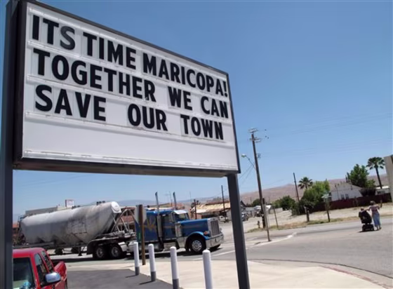 In this photo taken June 13, 2011, a sign is seen outside of the Shell gas station in Maricopa, Calif. Its own county grand jury has recommended that this tiny San Joaquin Valley community be dissolved because It's too poor to be a town anymore. 